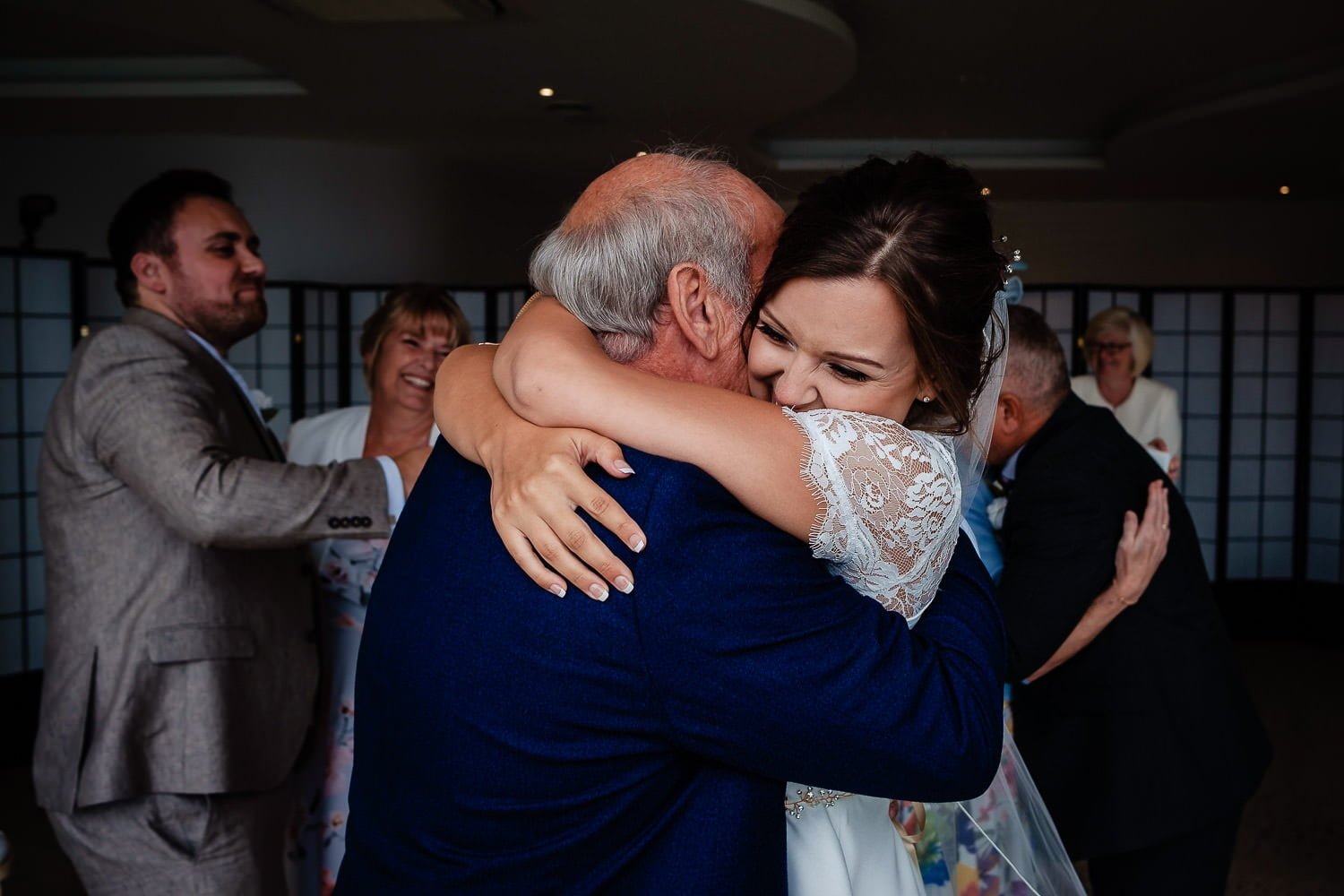bride hugging her dad at sandy cove wedding