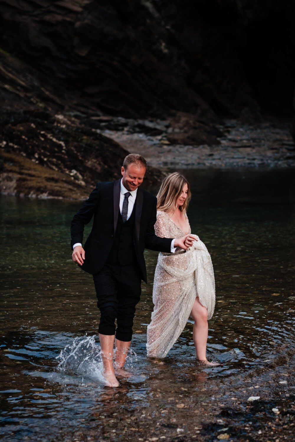 bride & groom having a paddle - Watermouth Cove Wedding Photographer
